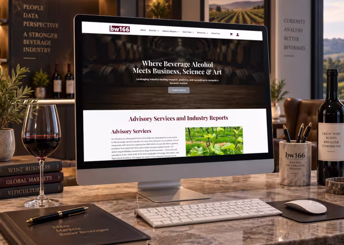 bw166 website on iMac sitting on wood grain desk.